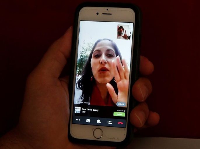 Sergio Colas communicates with his wife Alma via FaceTime so that they can read each others lips during the San Fermin festival in Pamplona, northern Spain, July 7, 2016. REUTERS/Susana Vera SEARCH "SERGIO COLAS" FOR THIS STORY. SEARCH "THE WIDER IMAGE" FOR ALL STORIES.