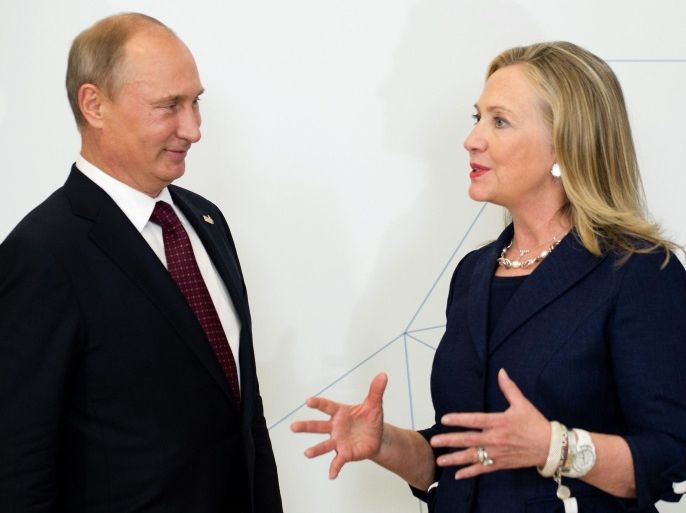 U.S. Secretary of State Hillary Clinton (R) talks with Russian President Vladimir Putin during the arrival ceremony for the Asia-Pacific Economic Cooperation (APEC) Summit in Vladivostok, Russia on September 8, 2012. REUTERS/Jim Watson/Pool/File Photo