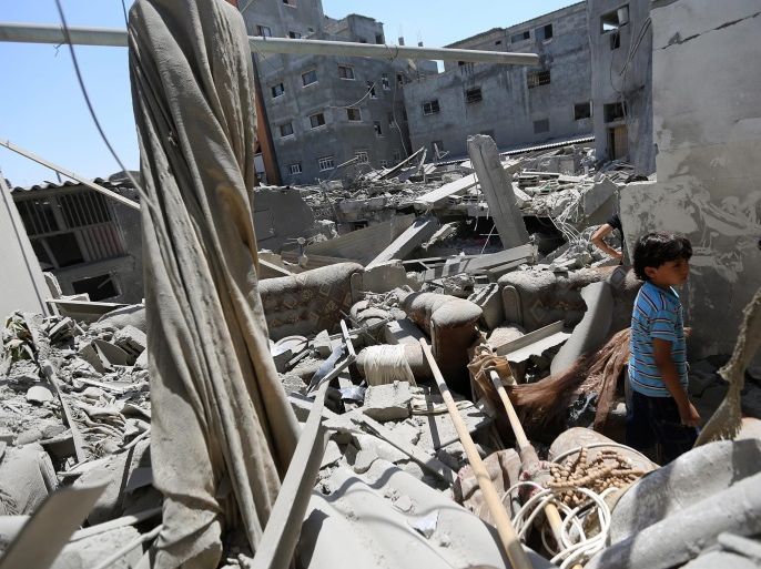 A young Palestinian boy inspects the rubble of a destroyed house after an Israeli airstrike, in Jabaliya refugee camp, northern Gaza Strip, 25 August 2014. Six Palestinians were killed in the Gaza Strip on 25 August in fresh Israeli air raids, the Health Ministry in the coastal territory said.