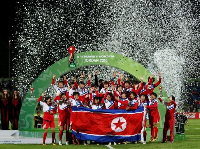 Football Soccer - North Korea v Japan - U-17 Women's World Cup - Amman, Jordan - 21/10/16. North Korea players celebrate with their trophy after their victory in the final against Japan. REUTERS/Muhammad Hamed