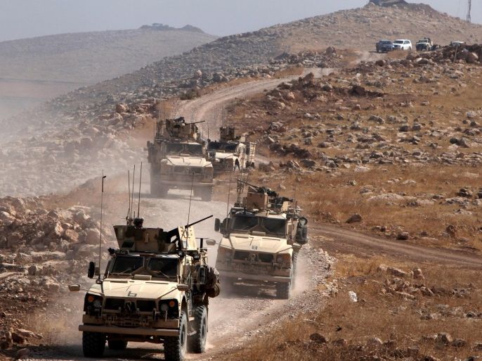 A convoy of armoured vehicles belonging to international coalition troops drive during the operation against Islamic State militants outside the town of Naweran near Mosul, Iraq October 23, 2016. REUTERS/Azad Lashkari