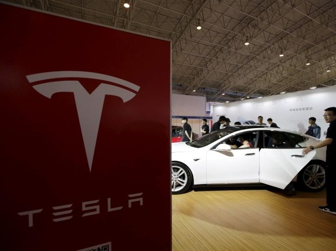 People visit a Tesla Model S car during the Auto China 2016 in Beijing, China, April 25, 2016. REUTERS/Jason Lee/File Photo