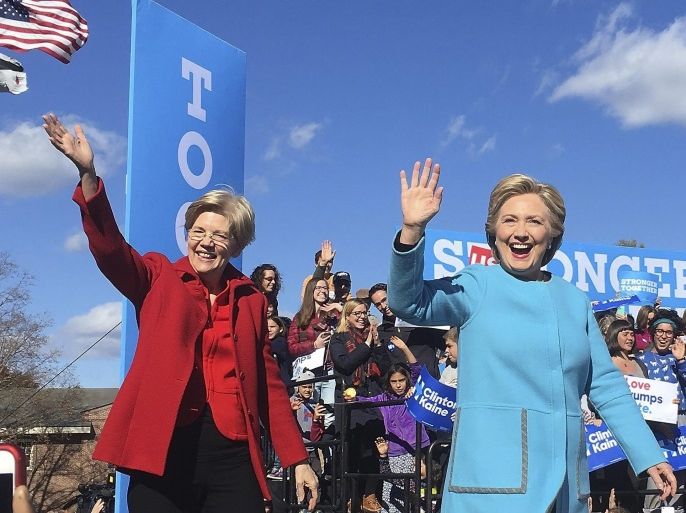 US Senator Elizabeth Warren (L) and Democratic Candidate for US President Hillary Clinton (R) wave as they arrive to a campaign rally at St Anselm College in Manchester, New Hampshire, USA 24 October 2016. The USA general election will take place on 08 November.