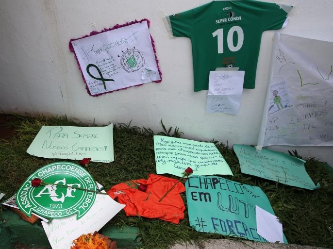 Flowers and messages are seen next to a Chapecoense soccer team flag in tribute to their players in front of the Arena Conda stadium in Chapeco, Brazil, November 29, 2016. REUTERS/Paulo Whitaker