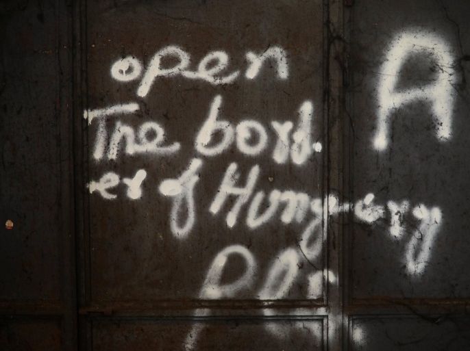 A graffiti reading "Open the border of Hungary pls" is seen on a wall of a derelict customs warehouse occupied by migrants in Belgrade, Serbia, November 11, 2016. REUTERS/Marko Djurica SEARCH "MIGRANTS WAREHOUSE" FOR THIS STORY. SEARCH "WIDER IMAGE" FOR ALL STORIES.
