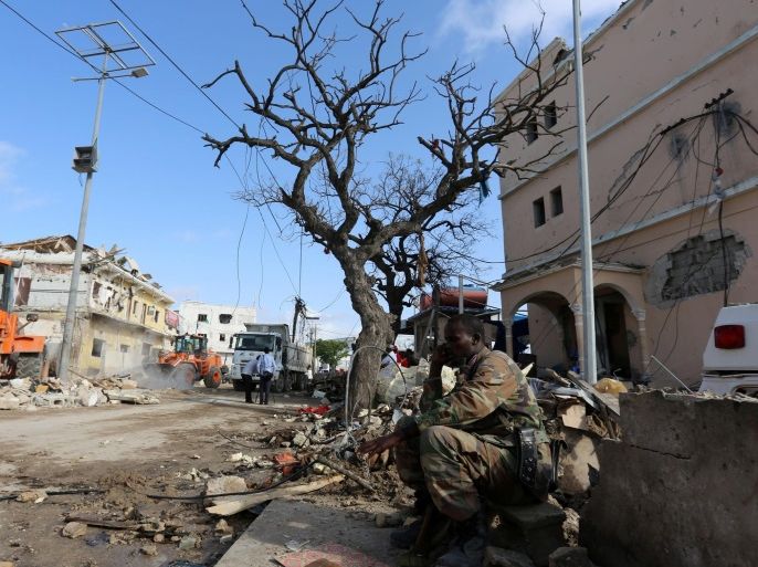 A Somali government soldier sits near the scene of a suicide bomb attack outside Nasahablood hotel in Somalia's capital Mogadishu, June 26, 2016. REUTERS/Feisal Omar