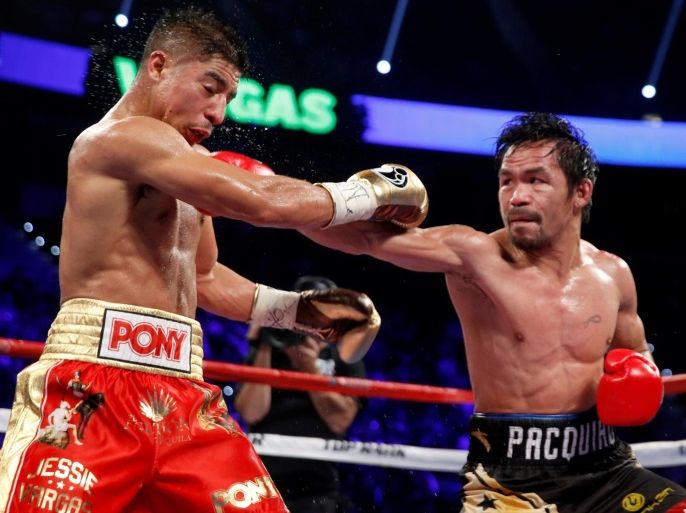 WBO welterweight champion Jessie Vargas (L) of Las Vegas takes a punch from Manny Pacquiao of the Philippines during their title fight at the Thomas & Mack Center in Las Vegas, Nevada, U.S., November 5, 2016. REUTERS/Las Vegas Sun/Steve Marcus