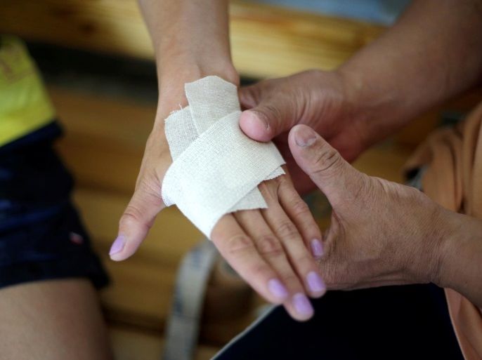A coach wraps bandage on the hand of Mongolia's Olympic wrestler Battsetseg Soronzonbold during a daily training session at the Mongolia Women’s National Wrestling Team training centre in Bayanzurkh district of Ulaanbaatar, Mongolia, July 1, 2016. REUTERS/Jason Lee SEARCH "UNBREAKABLE FLOWER" FOR THIS STORY. SEARCH "THE WIDER IMAGE" FOR ALL STORIES.