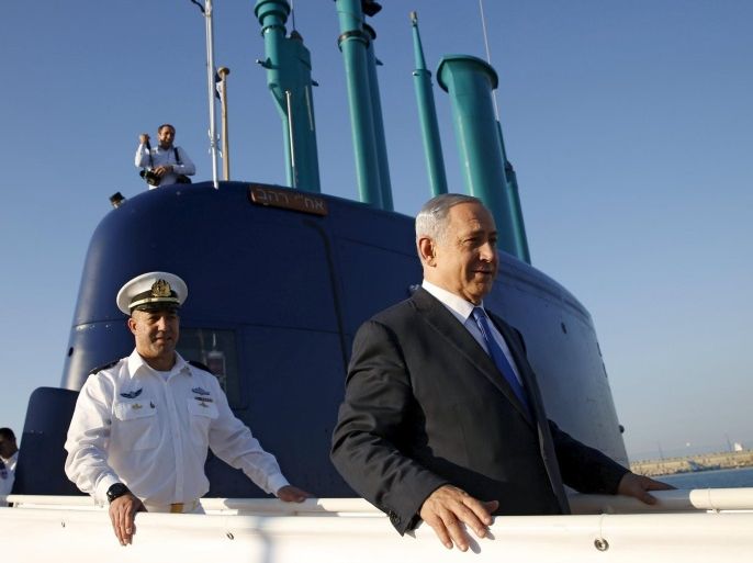 Israeli Prime Minister Benjamin Netanyahu (R) walks on the Rahav, the fifth submarine in the fleet, after it arrived in Haifa port January 12, 2016. The Dolphin-class submarines, widely believed to be capable of firing nuclear missiles, were manufactured in Germany and sold to Israel at deep discounts as part of Berlin's commitment to shoring up the security of the country set in part as a haven for Jews who survived the Holocaust.REUTERS/Baz Ratner