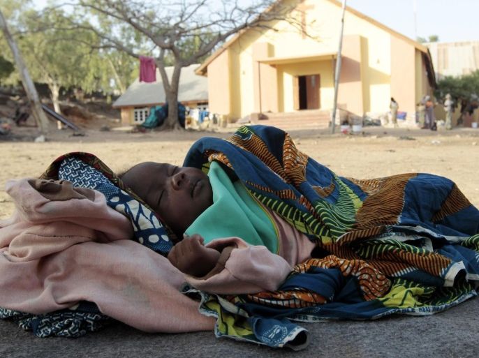 Baby Lurky, whose family was displaced as a result of Boko Haram attacks in the northeast region of Nigeria, sleeps in the shade at a camp for internally displaced people (IDP) in Yola, Adamawa State January 14, 2015. Boko Haram says it is building an Islamic state that will revive the glory days of northern Nigeria's medieval Muslim empires, but for those in its territory life is a litany of killings, kidnappings, hunger and economic collapse. Baby Lurky is one of ove