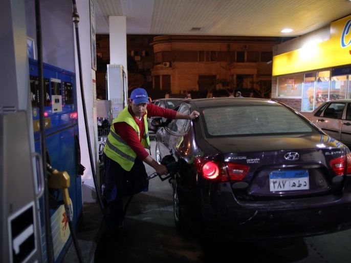 An Egyptian worker at a gas station fills a car at a fuel station in Cairo, Egypt, early 04 November 2016. The Egyptian government raised fuel prices on 04 November to rein in the runaway budget deficit, the increases, covering the prices of petrol, diesel and natural gas used for cars, are between 40 per cent and 77 per cent, according to local media.