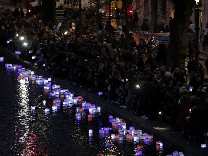 People release floats lit with candles on the Canal Saint-Martin, in Paris, France, November 13, 2016, after ceremonies held for the victims of last year's Paris attacks which targeted the Bataclan concert hall as well as a series of bars and killed 130 people. REUTERS/Benoit Tessier