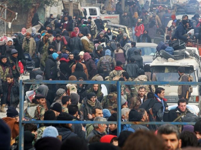 FILE PHOTO - Rebel fighters and civilians gather as they wait to be evacuated from a rebel-held sector of eastern Aleppo, Syria December 16, 2016. REUTERS/Abdalrhman Ismail/File Photo