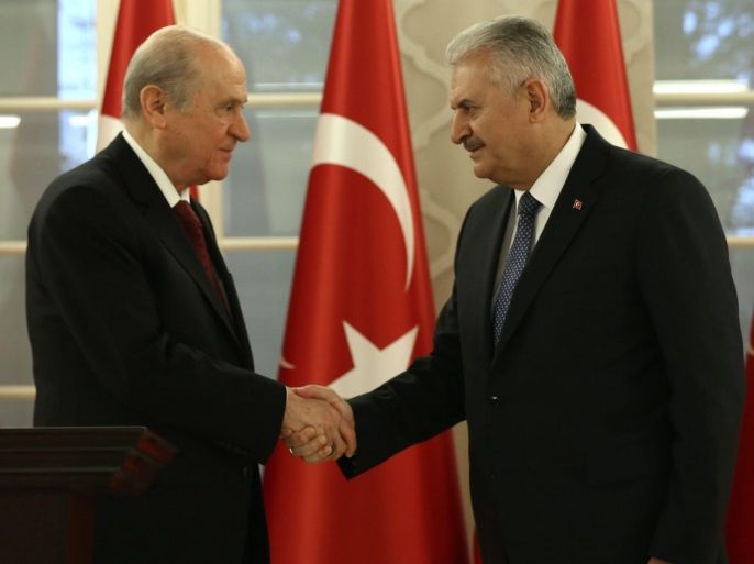 A handout picture provided by the Turkish Prime Minister's Press office on 01 December 2016 shows Turkish Prime Minister Binali Yildirim (R) shaking hands after a meeting with Devlet Bahceli (L), leader of the oppositional Nationalist Movement Party (MHP), in Ankara, Turkey, 01 December 2016. The two leaders meet to discuss the draft constitutional amendment, including an executive presidential system and they announced that they agreed on the new presidential system o