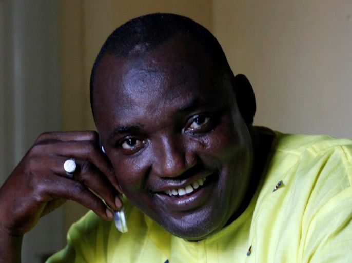 The new president of Gambia, Adama Barrow smiles as he makes a call at his home in Yarambamba, West Coast Region, Gambia December 3, 2016. REUTERS/ Thierry Gouegnon