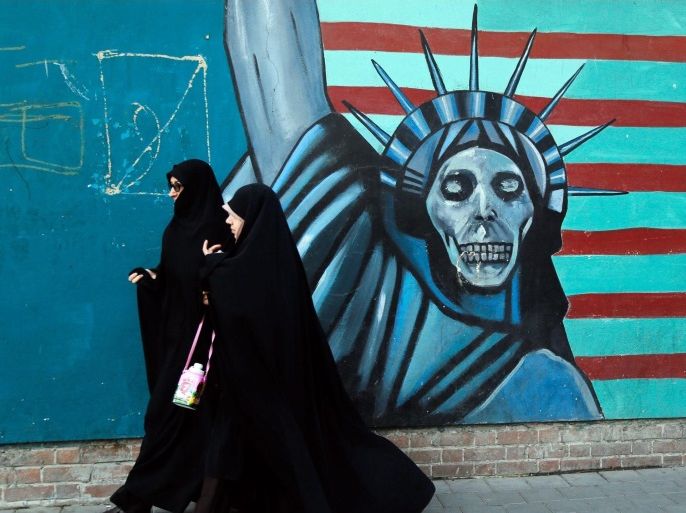 (FILE) A file picture dated 03 November 2016 shows Iranian women pass next to an anti-US mural on their way to the former US embassy in Tehran to attend a demonstration marking the 37th anniversary of US Embassy takeover, in front of the former US embassy in Tehran, Iran. On 09 November 2016 Media Reported that Iranian President Hassan Rouhani made an announcement following the victory of US president-elect Donald Trump that there was 'no possibility' of irans nuclear