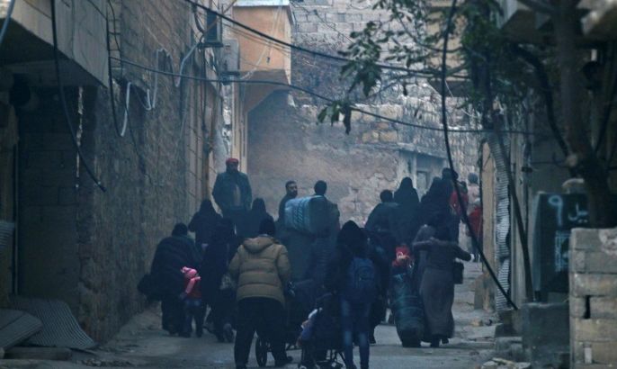 People carry belongings as they flee deeper into the remaining rebel-held areas of Aleppo, Syria December 12, 2016. REUTERS/Abdalrhman Ismail