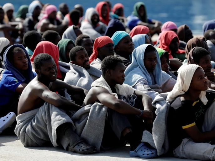 Migrants rests after disembarking from Dignity ship in the Sicilian harbour of Augusta, Italy, October 19, 2016. To match Insight EUROPE-MIGRANTS/ITALY-HOTSPOTS REUTERS/Antonio Parrinello/File Photo