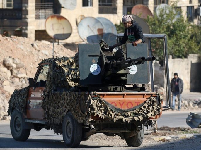 A rebel fighter stands on a pick-up truck mounted with a weapon in a rebel-held area of Aleppo, Syria December 9, 2016. REUTERS/Abdalrhman Ismail