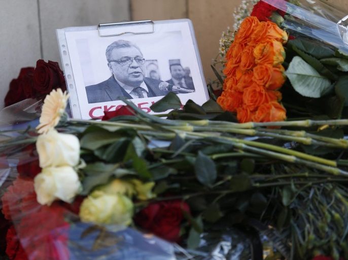 Flowers lie near a picture of Russia's ambassador to Turkey Andrey (Andrei) Karlov outside the Russian foreign ministry in Moscow, Russia, 20 December 2016. Russia's ambassador to Turkey, Andrey Karlov was shot on 19 December at an art exhibition in the Turkish capital Ankara. Karlov died of his wounds after the attack, Russia's Ministry of Foreign Affairs confirmed the previous day.