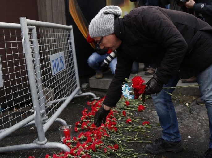 People place flowers and candles at a police barrier in front of the Reina night club following a gun attack at the popular night club in Istanbul close to the Bosphorus river, in Istanbul, Turkey, 01 January 2017. At least 39 people were killed and 65 others were wounded in the attack, local media reported.