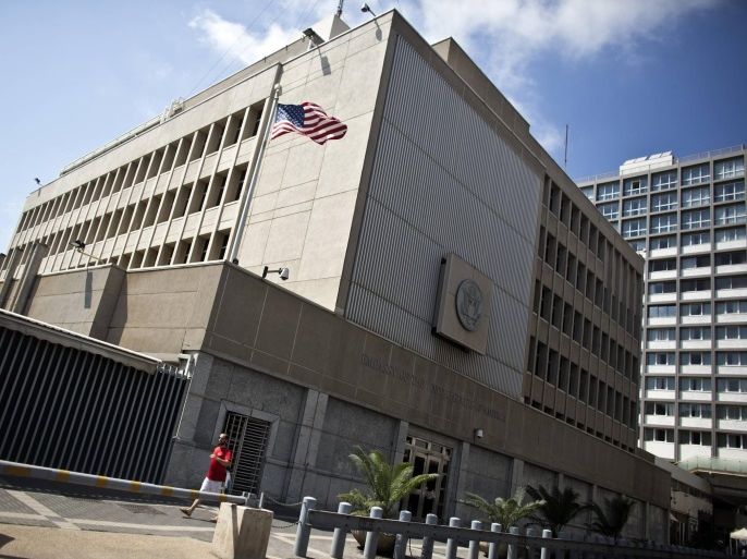 A pedestrian walks past the U.S. embassy in Tel Aviv August 5, 2013. The United States extended embassy closures by a week in the Middle East and Africa as a precaution on Sunday after an al Qaeda threat that U.S. lawmakers said was the most serious in years. The United States initially closed 21 U.S. diplomatic posts for the day on Sunday. Some of those reopened on Monday, including Kabul, Baghdad, Algiers and Israel. REUTERS/ Nir Elias (ISRAEL - Tags: POLITICS)