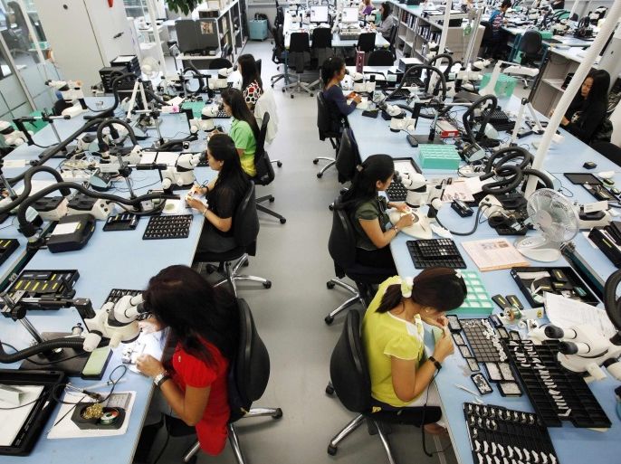 Employees work in the production facility of Phonak hearing devices of Swiss hearing aid maker Sonova at the company's headquarters in the village of Staefa east of Zurich, in this September 5, 2012 file photo. Sonova, the world's largest maker of hearing aids, said on March 2, 2015 it would move more jobs out of Switzerland and freeze pay for its Swiss staff, in the latest move by a Swiss firm to slash costs to deal with a surge in the franc. REUTERS/Michael Buholzer