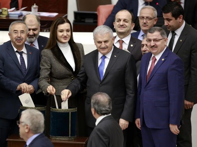Turkish Prime Minister Binali Yildirim (R-2) casts his vote during the second tour debating a reform of the constitution, at the Turkish parliament in Ankara, Turkey, 18 January 2017. Turkish parliament debating a reform of the constitution to change the country's parliamentarian system of governance into a presidential one, which the opposition denounced as giving more power to Turkish president Recep Tayyip Erdogan.