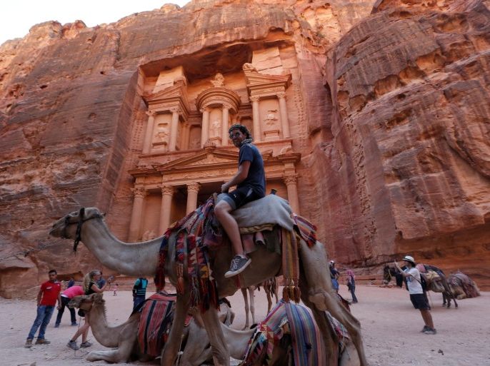 Tourists take pictures in front of the Treasury site during their visit to the ancient city of Petra, south of Amman, Jordan, July 23, 2016. REUTERS/Muhammad Hamed