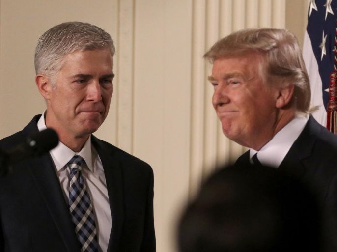 U.S. President Donald Trump looks on as Neil Gorsuch (L) approaches the podium after being nominated to be an associate justice of the U.S. Supreme Court at the White House in Washington, D.C., U.S., January 31, 2017. REUTERS/Carlos Barria