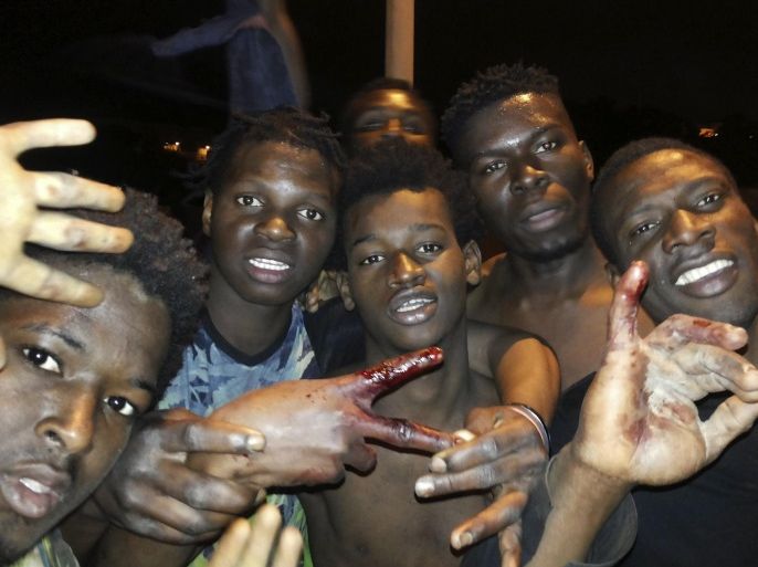 A group of sub-Saharan men poses for photographs in the city of Ceuta, the Spanish enclave in northern Africa, after they managed to jump the border fences between Spain and Morocco, in Ceuta, Spain, early morning 20 February 2017. Some 350 migrants crossed the Spanish border in a joint jump early morning as the city was hit by heavy rainfalls and strong winds. Spanish Red Cross members had to take care of some migrants who were injured. The action happened just three d