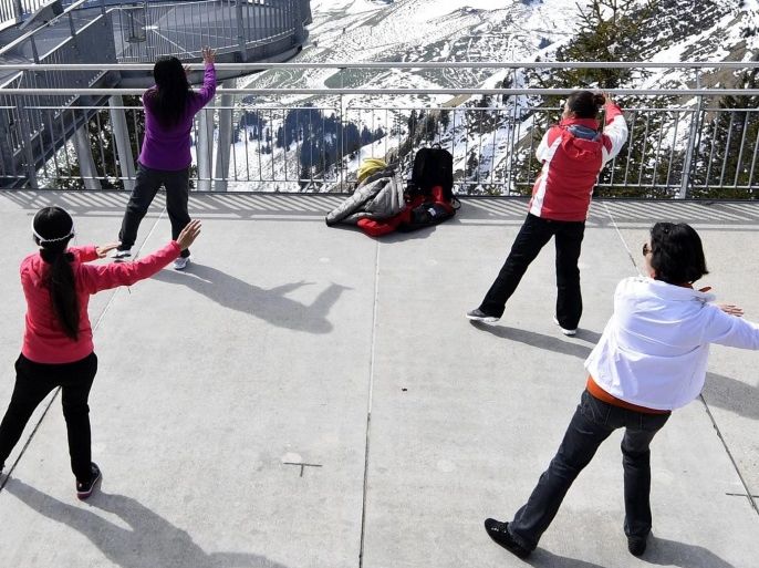 Chinese tourists practice Tai Chi up the Stanserhorn mountain, Switzerland, 30 April 2016.