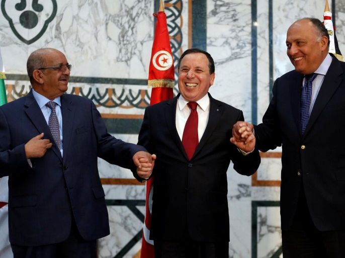 Tunisia's Foreign Minister Khemaies Jhinaoui (C) shakes hands with Algerian Minister of Maghreb Affairs, African Union and Arab League Abdelkader Messahel (L) and his Egyptian counterpart Sameh Shoukry in Tunis, Tunisia February 19, 2017. REUTERS/Zoubeir Souissi