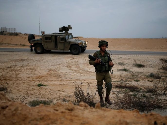 An Israeli soldier patrols the Israeli side of the Israel-Gaza border January 25, 2017. REUTERS/Amir Cohen