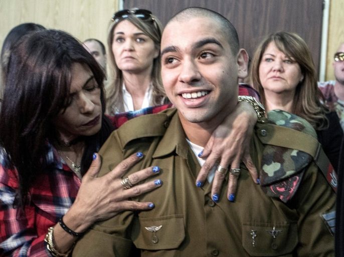Israeli soldier Elor Azaria is embraced by his mother at the start of is sentencing hearing at a military court in Tel Aviv, Israel February 21, 2017. REUTERS/Jim Hollander/Pool