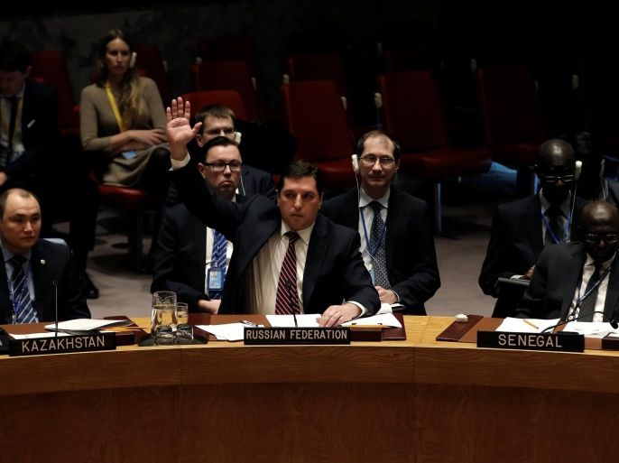 Russian Deputy Ambassador to the United Nations Vladimir Safronkov raises his arm to vote against a United Nations Security Council resolution to ban the supply of helicopters to the Syrian government and to blacklist Syrian military commanders over accusations of toxic gas attacks at U.N. headquarters in New York City, U.S., February 28, 2017. REUTERS/Mike Segar