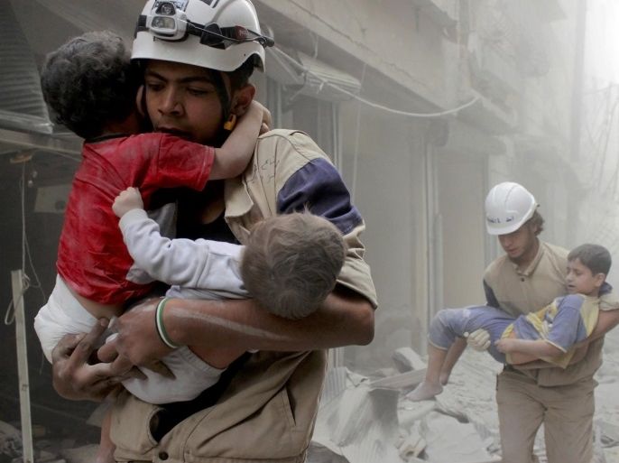 FILE PHOTO - Members of the Civil Defence rescue children after what activists said was an air strike by forces loyal to Syria's President Bashar al-Assad in al-Shaar neighbourhood of Aleppo, Syria June 2, 2014. REUTERS/Sultan Kitaz/File Photo