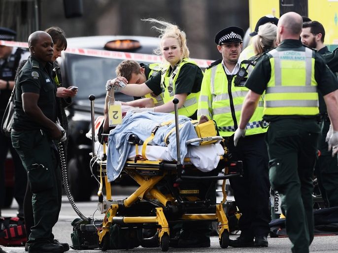 LONDON, ENGLAND - MARCH 22: A member of the public is treated by emergency services near Westminster Bridge and the Houses of Parliament on March 22, 2017 in London, England. A police officer has been stabbed near to the British Parliament and the alleged assailant shot by armed police. Scotland Yard report they have been called to an incident on Westminster Bridge where several people have been injured by a car. (Photo by Carl Court/Getty Images)
