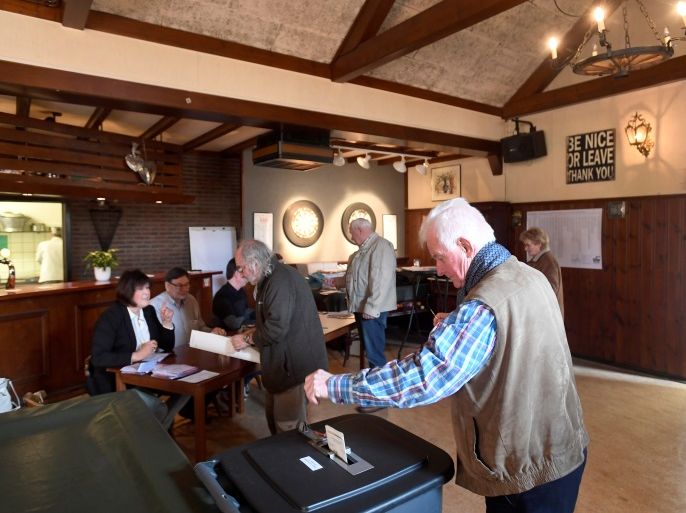 People vote in a bar used as a polling station in Ankeveen, Netherlands, March 15, 2017. REUTERS/Toussaint Kluiters