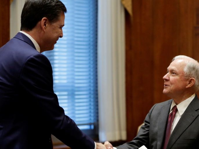 U.S. Attorney General Jeff Sessions (R) shakes hands with FBI Director James Comey before his first meeting with heads of federal law enforcement components at the Justice Department in Washington, U.S., February 9, 2017. REUTERS/Yuri Gripas