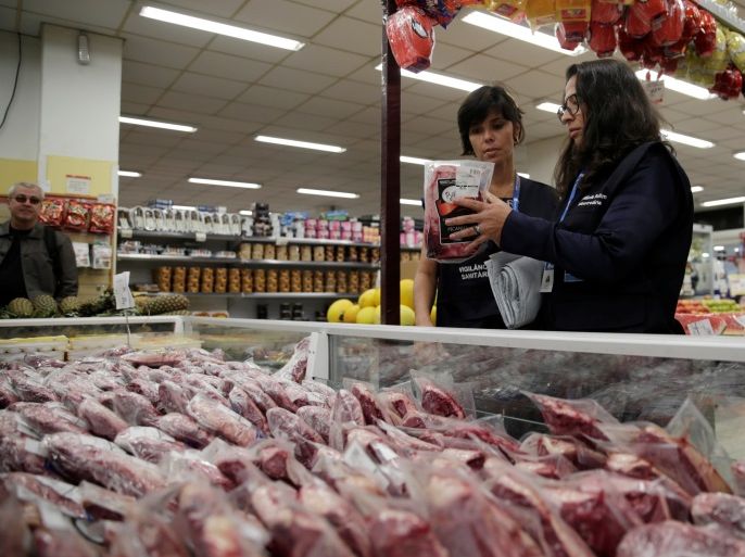 Members of the Public Health Surveillance Agency collect meats to analyse in their laboratory, at a supermarket in Rio de Janeiro, Brazil, March 20, 2017. REUTERS/Ricardo Moraes