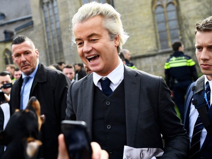 Dutch far-right politician Geert Wilders of the PVV party reacts as a dog barks at him as he campaigns in Valkenburg, Netherlands, March 11, 2017. REUTERS/Dylan Martinez