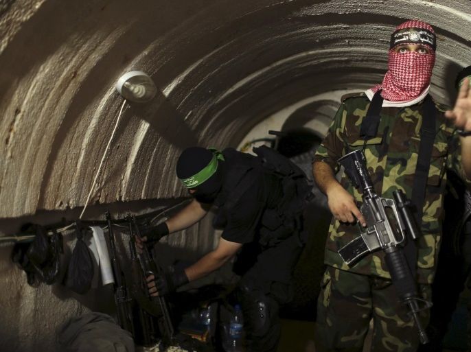 A Palestinian fighter from the Izz el-Deen al-Qassam Brigades, the armed wing of the Hamas movement, gestures inside an underground tunnel in Gaza in this August 18, 2014 file photo. The Israeli government says its investigations have not come up with any evidence the night-time noises reported by villagers living near Gaza emanate from tunnels, but assertions by Hamas of extensive cross-border digging has only fueled concern. REUTERS/Mohammed Salem/Files