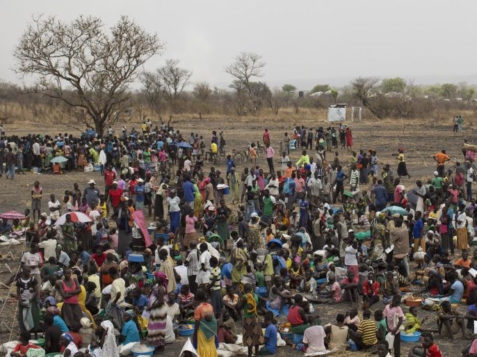 PALORINYA, MOYO DISTRICT - FEBRUARY 25: Refugees queue at a World Food Programme (WFP) food distribution site at a refugee settlement on February 25, 2017 in Palorinya, Uganda. After registering their details families receive food including Maize Flour, Vegetable Oil, Beans and Salt. The continued flow of refugees from South Sudan, is putting pressure on the many humanitarian partners, and their capacity to cope with the crisis. The United Nations have said that more th