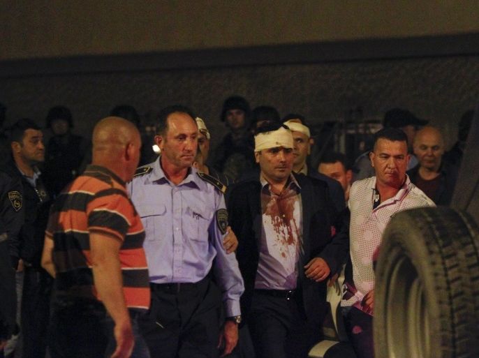 Macedonian police escorts injured members of the parliament including Social Democratic leader Zoran Zaev near the parliament in Skopje. Macedonia April 27, 2017. REUTERS/Ognen Teofilovski