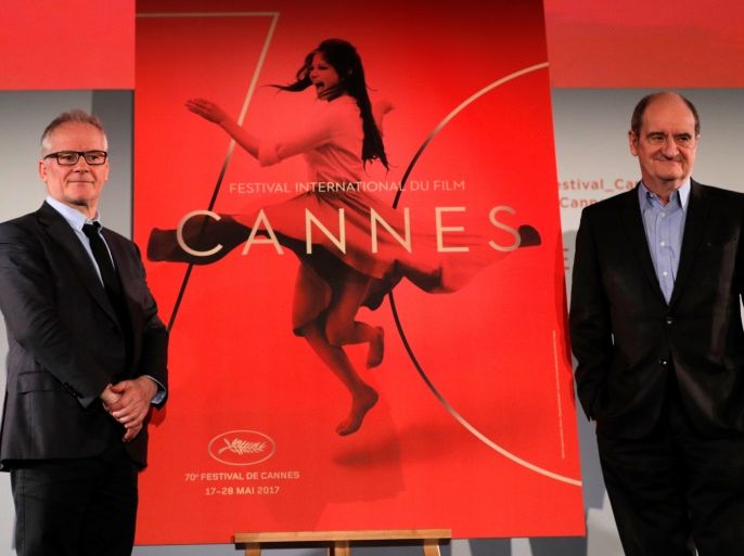 Cannes Film festival general delegate Thierry Fremaux (L) and Cannes Film festival president Pierre Lescure (R) pose in front of the official poster for the 70th Cannes Film Festival after a news conference, to announce this year's official selection, in Paris, France, April 13, 2017. REUTERS/Philippe Wojazer