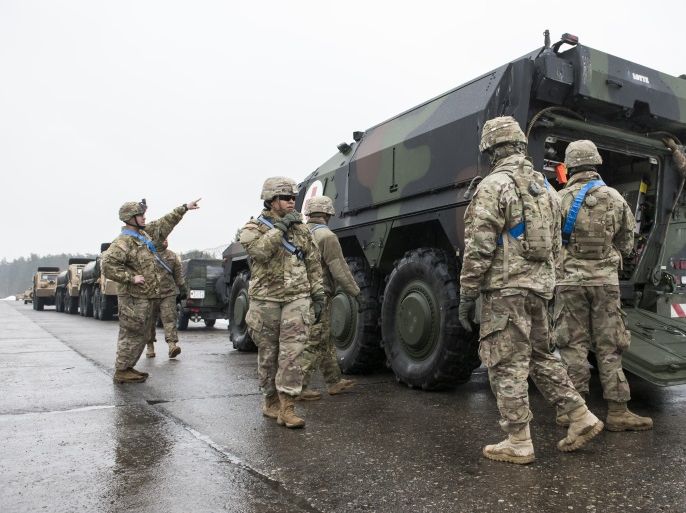 GRAFENWOEHR, GERMANY - JANUARY 31: U.S. soldiers have a closer look at Boxer military vehicles waiting for loading on a train in order to ship them and other equipment to Lithuania on January 31, 2017 in Grafenwoehr, Germany. The Bundeswehr is sending approximately 450 troops to Lithuania as part of the NATO military alliance's 'Enhanced Forward Presence' mission, in which multi-national battalions of 1,000 soldiers each are to be stationed in Poland and the three Ba