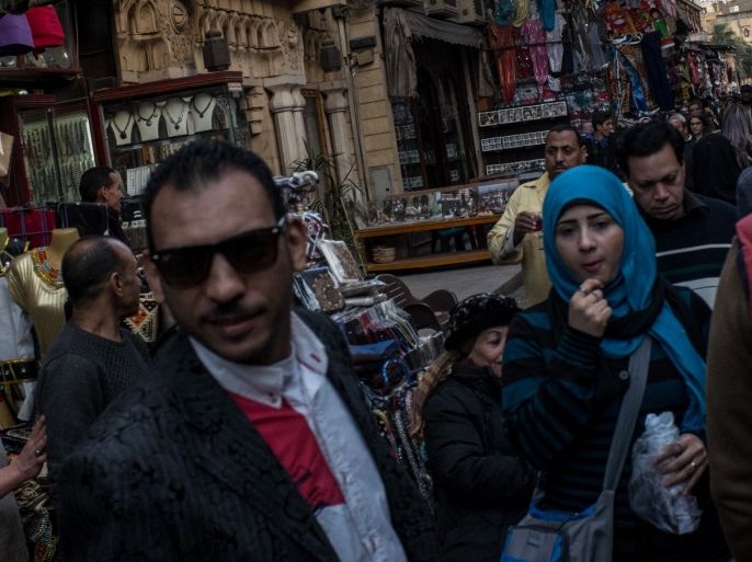 CAIRO, EGYPT - DECEMBER 14: People walk past a man selling local clothing ona market street in the Old Cairo district on December 14, 2016 in Cairo, Egypt. Since the 2011 Arab Spring, Egyptians have been facing a crisis, the uprising brought numerous political changes, but also economic turmoil, increased terror attacks and the unravelling of the once strong tourism sector. In recent weeks Egypt has again been hit by multiple bomb blasts, the most recent killed 26 Chr