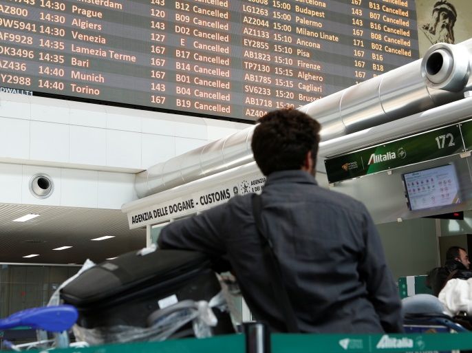 Boards display flights cancellations as a passenger waits during a strike of Alitalia employees at Rome's Fiumicino international airport in Rome, Italy February 23, 2017. REUTERS/Remo Casilli