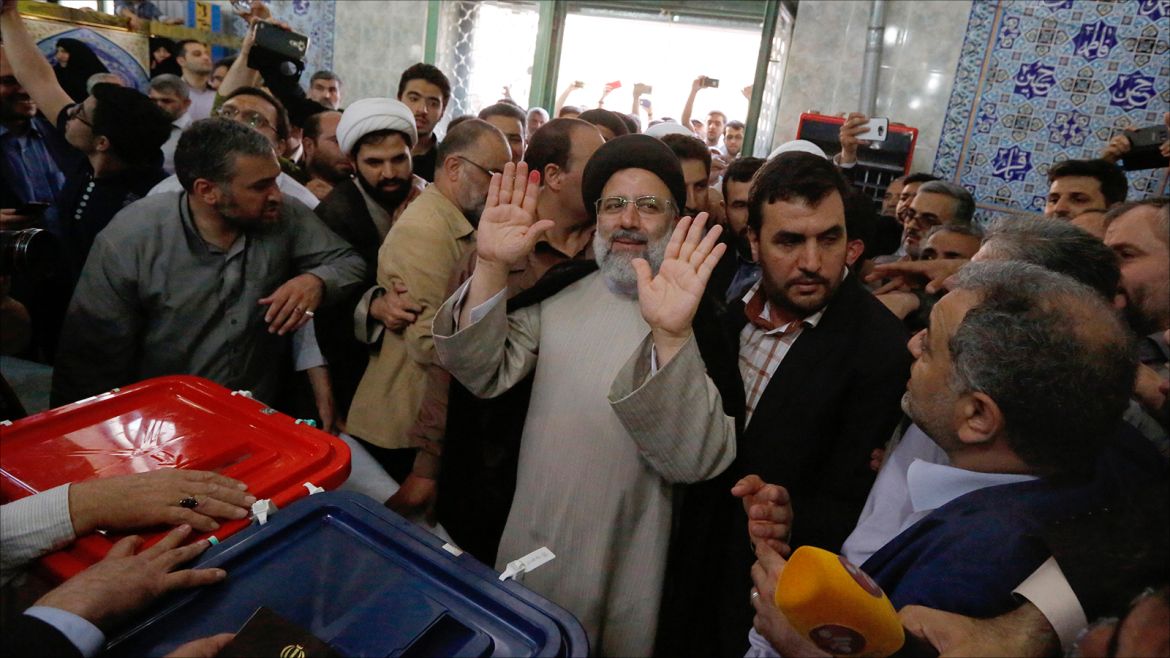 epaselect epa05973538 Iranian conservative presidential candidate Ebrahim Raisi (C) greets people as he casts his ballot during the presidential elections at a polling station in the city of Shahre-Ray, south of Tehran, Iran, 19 May 2017. Out of the candidates, the race is tightest between frontrunners Iranian current president Hassan Rouhani and conservative presidential candidate Ebrahim Raisi.  EPA/ABEDIN TAHERKENAREH